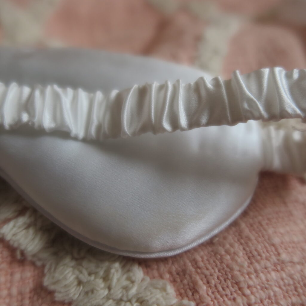 Close up image of the elasticated headband coated in luxury silk